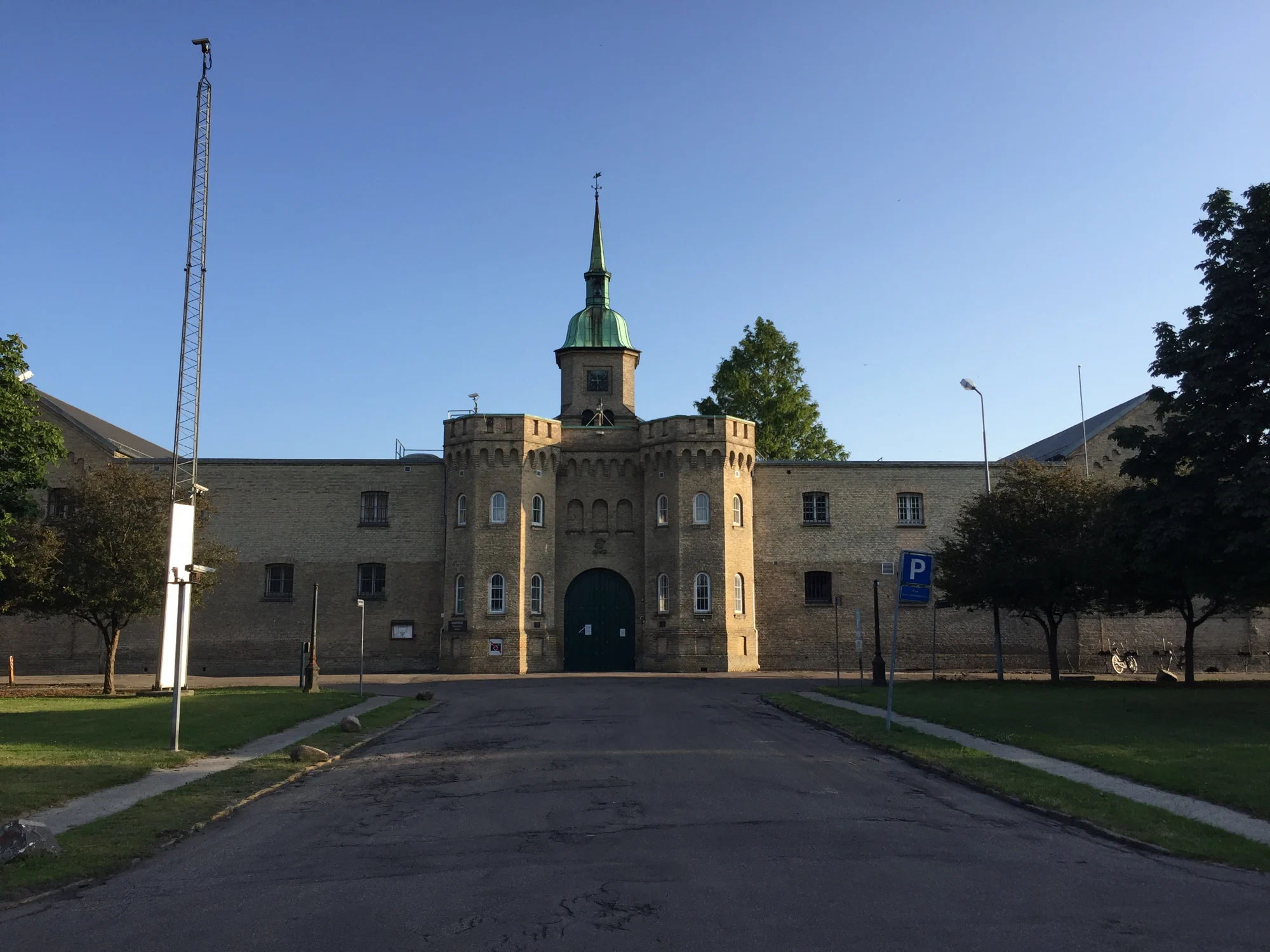 Vridsløselille Statsfængsels hovedbygning med tårn, gul murstensfacade og grøn port